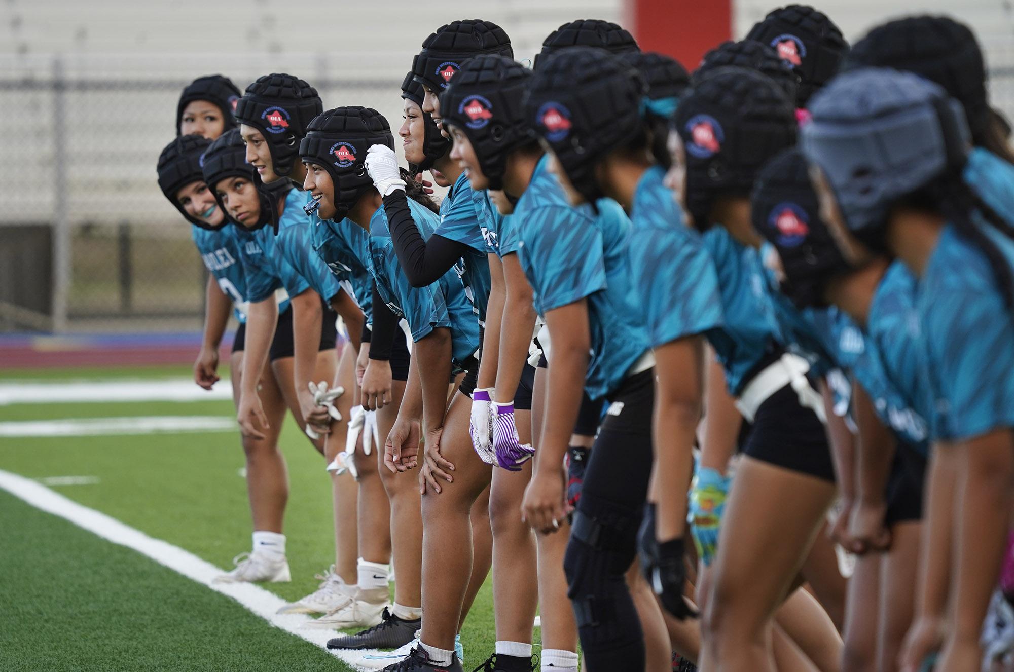 Kapolei High School flag football players run sprints before Hawaii's first girls high school flag football game on March 25, 2025.