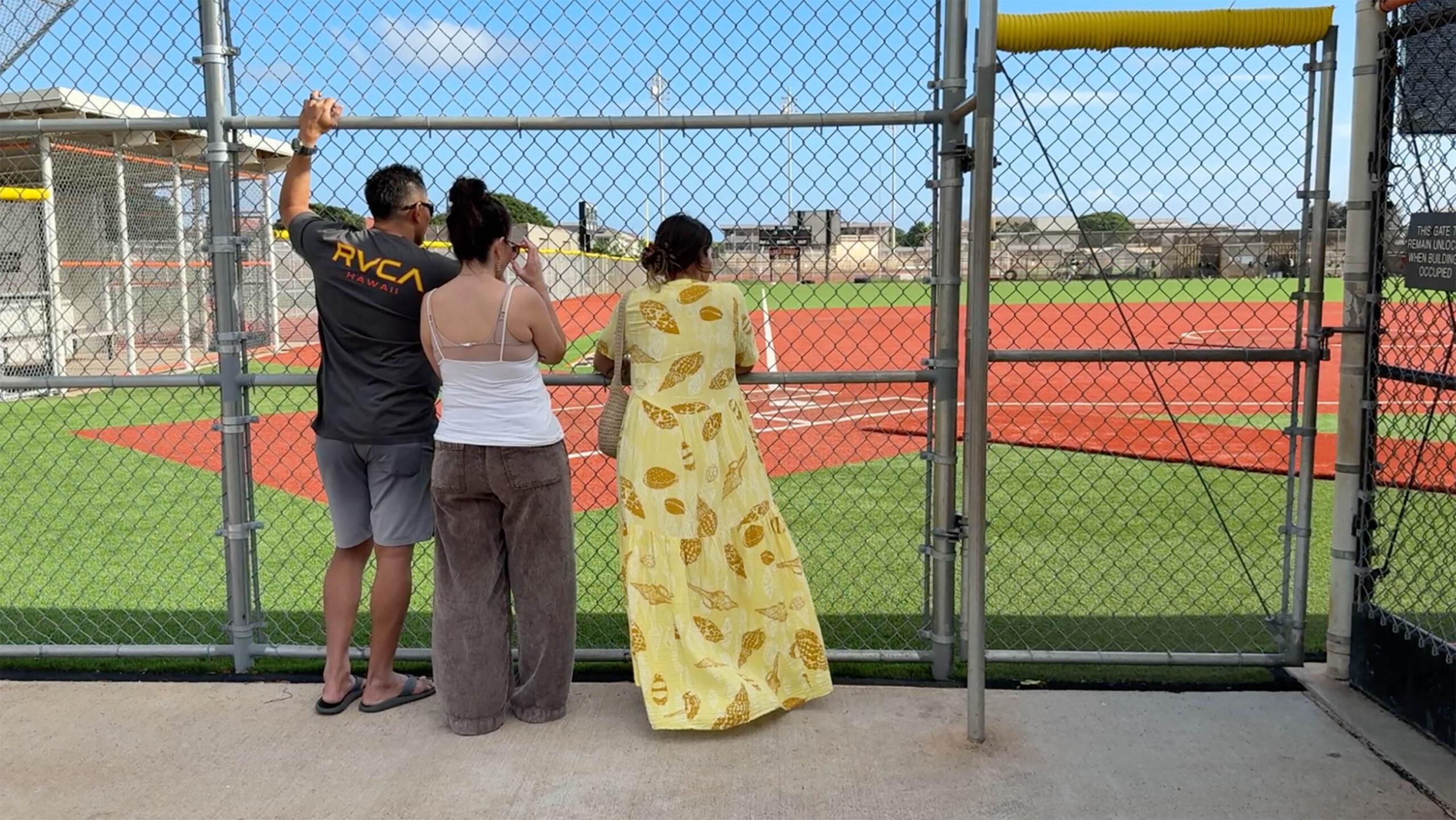 Ashley, right, looks at the Campbell High’s new softball field with her parents.