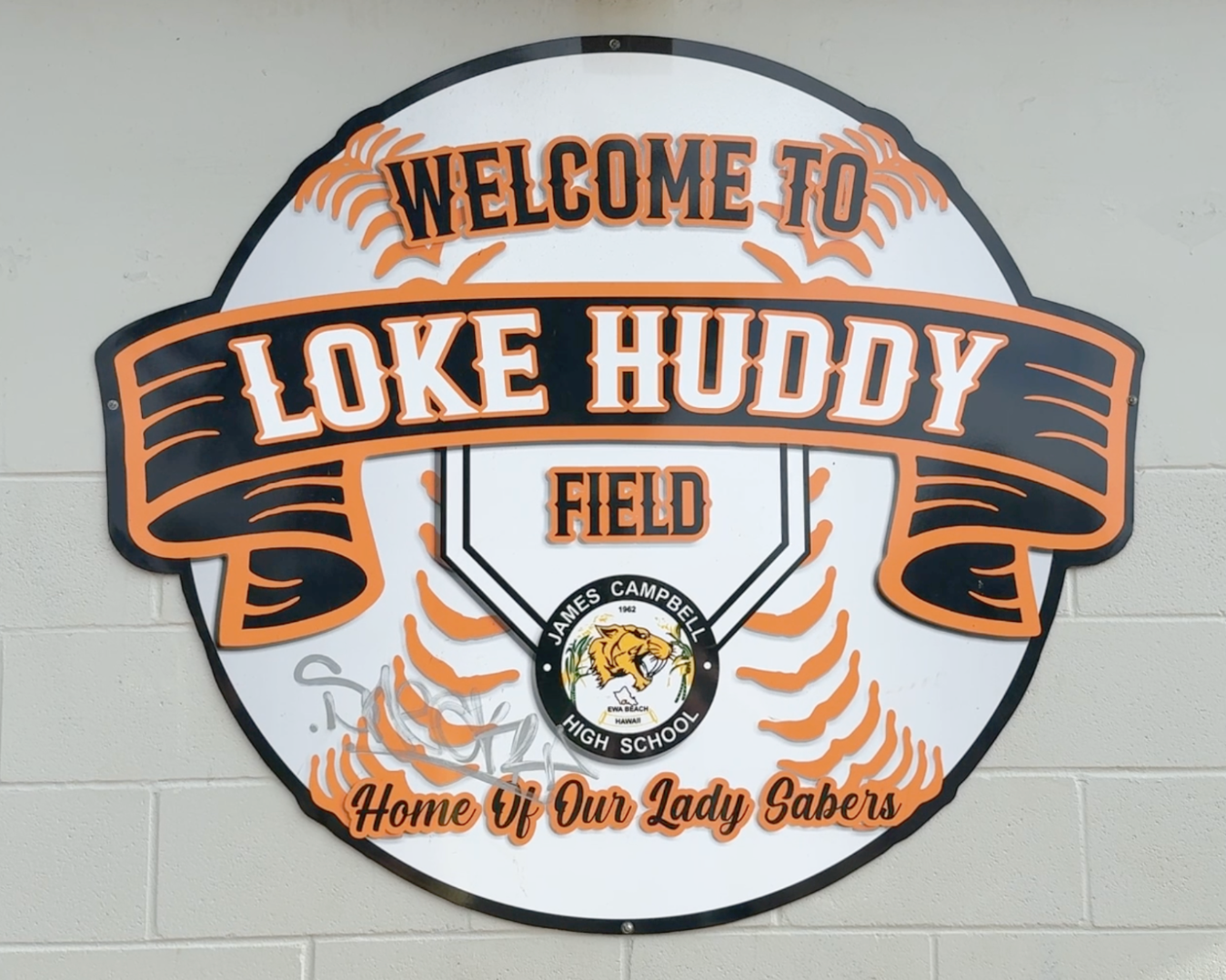 A decal outside Campbell High's softball stadium says "Welcome to Loke Huddy Field."